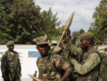 Congolese soldiers rearm as they arrive in Bunagana, north of Goma