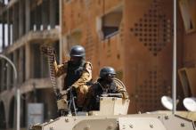 Soldiers stand guard in an armoured vehicle outside the Splendid Hotel after al Qaeda militants killed at least 28 people from at least seven countries in an attack on the hotel and a restaurant in Ouagadougou, Burkina Faso, January 18, 2016. PHOTO BY REUTERS/Joe Penney