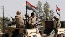 Soldiers in military vehicles proceed towards the al-Jura district in El-Arish city from Sheikh Zuwaid, around 350 km (217 miles) northeast of Cairo, May 21, 2013. PHOTO BY REUTERS/Stringer