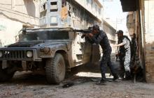 Iraqi Federal Police fires his rifle at Islamic State fighters' positions at Bab al Jadid district in the old city of Mosul, Iraq, March 26, 2017. PHOTO BY REUTERS/Youssef Boudlal