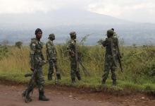 Soldiers from the Democratic Republic of Congo (DRC) look at the distant hills near the town of Kibumba at its border with Rwanda after fighting broke out in the Eastern Congo town, June 11, 2014. PHOTO BY REUTERS/Kenny Katombe