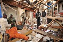 Soldiers and policemen are pictured at the scene where two female suicide bombers blew themselves up at a mobile phone market in the northern Nigerian city of Kano, November 18, 2015. PHOTO BY REUTERS/Stringer 