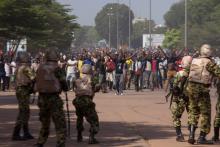 Soldiers attempt to stop anti-government protesters from entering the parliament building in Ouagadougou, capital of Burkina Faso, October 30, 2014. PHOTO BY REUTERS/Joe Penney