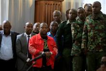 Prison and police officers keep watch over Nairobi's Governor Mike Sonko as he appears for a hearing on his bond application after he was arrested on corruption-related charges, at the Milimani Law Courts in Nairobi, Kenya, December 11, 2019. PHOTO BY REUTERS/Njeri Mwangi