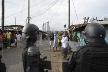 Liberian security forces stand in front of protesters after clashes at West Point neighbourhood in Monrovia