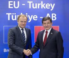 Turkish Prime Minister Ahmet Davutoglu (R) is welcomed by European Council President Donald Tusk at the start of an EU-Turkey summit, in which the EU seeks Turkish help to slow the influx of migrants into southeastern Europe, in Brussels, Belgium, November 29, 2015. PHOTO BY REUTERS/Thierry Monasse