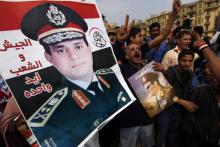 Supporters of Egypt's army chief General Abdel Fattah al-Sisi hold up a poster of Sisi