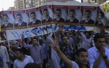 Supporters of the Muslim Brotherhood and ousted Egyptian President Mohamed Mursi shout slogans against the military and interior ministry