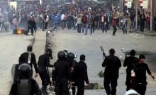 Supporters of the Muslim Brotherhood and ousted Egyptian President Mohamed Mursi run after riot police fired tear gas during clashes in Cairo