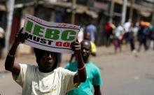 A supporter of Kenya's opposition Coalition for Reforms and Democracy (CORD) carries a placard during a protest against at the Independent Electoral and Boundaries Commission (IEBC) to demand the disbandment of the electoral body ahead of next year's election in Nairobi, Kenya, June 6, 2016. PHOTO BY REUTERS/Thomas Mukoya