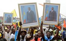 Supporters of Congolese President Joseph Kabila carry his portrait photographs during a pro-government rally in the Democratic Republic of Congo's capital Kinshasa, July 29, 2016. PHOTO BY REUTERS/Kenny Katombe