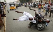 Supporters of the presidential candidate Muhammadu Buhari and his All Progressive Congress hits another supporter with a motorbike during celebrations in Kano, March 31, 2015. PHOTO BY REUTERS/Goran Tomasevic