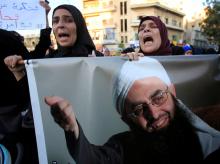 Supporters of detained Lebanese hardline Sunni Islamist cleric Ahmad al-Assir carry his picture as they protest after a Lebanese military court sentenced him to death by execution, in Sidon, southern Lebanon, September 28, 2017. PHOTO BY REUTERS/Ali Hashisho