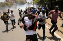 Supporters of the opposition National Super Alliance (NASA) coalition run as riot policemen fire tear gas to diperse them during a protest calling for the sacking of election board officials involved in August's cancelled presidential vote, in Nairobi, Kenya, October 6, 2017. PHOTO BY REUTERS/Thomas Mukoya