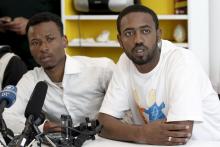 Survivors of recent shipwreck at an unknown location between Libya and Italy, Isman Mowlid of Somalia (L) and Mahmud Muaz of Ethiopia attend a news conference in Athens, Greece, April 21, 2016. PHOTO BY REUTERS/Michalis Karagiannis