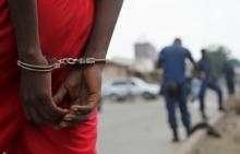 A suspect is handcuffed and detained by policemen after a grenade attack of Burundi's capital Bujumbura, February 3, 2016. PHOTO BY REUTERS/Jean Pierre Aime Harerimama