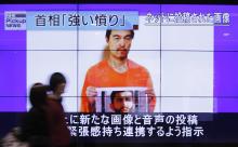 People walk past television screens displaying a news program, about an Islamic State video showing Japanese captive Kenji Goto, on a street in Tokyo, January 28, 2015. PHOTO BY REUTERS/Yuya Shino
