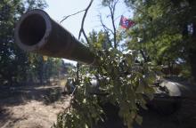 A barrel of a T-72 tank is seen with a flag of the DNR (Donetsk People's Republic) in the southern coastal town of Novoazovsk