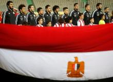 Team Egypt listens to the national anthem behind an Egyptian national flag ahead of the match. PHOTO BY REUTERS/Amr Abdallah Dalsh