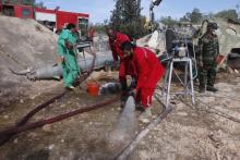 A team of Libyan experts and military engineers dump away fuel from expired SA-2 missiles, under the supervision of the United Nations, in Tripoli