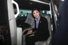 Thailand's Prime Minister Yingluck Shinawatra leaves the Government Complex after a meeting with the Election Commission in Bangkok