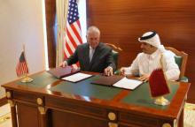 Qatar's foreign minister Sheikh Mohammed bin Abdulrahman al-Thani (R) and U.S. Secretary of State Rex Tillerson sign a memorandum of understanding in Doha, Qatar, July 11, 2017. PHOTO BY REUTERS/Naseem Zeitoon