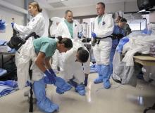 Participants wear protective clothing and equipment during training for the Ebola response team at Fort Sam Houston in San Antonio, Texas, October 24, 2014. PHOTO BY REUTERS/Darren Abate