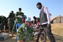 Medic peacekeepers from the United Nations Mission in the Republic of South Sudan (UNMISS) treat civilians at their compound in the outskirts of South Sudan's capital Juba