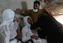 A man breathes through an oxygen mask as another one receives treatments, after what rescue workers described as a suspected gas attack in the town of Khan Sheikhoun in rebel-held Idlib, Syria, April 4, 2017. PHOTO BY REUTERS/Ammar Abdullah