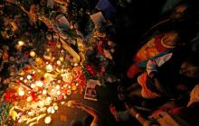 People pay tribute outside the house where former South African President Nelson Mandela resided in Johannesburg