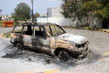 A damaged vehicle is seen after armed groups aligned with a U.N.-backed government took over a compound occupied by a self-declared rival prime minister in heavy fighting, in Tripoli, Libya, March 15, 2017. PHOTO BY REUTERS/Hani Amara