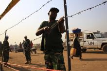 United Nations Mission in South Sudan (UNMISS) personnel erect barbed wire fencing around Tomping camp, where some 15,000 people who fled their homes following recent fighting are sheltered by the United Nations