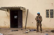 A United Nations peacekeeper stands guard near the scene where about 200 people were killed during an attack in Bentiu, Unity state of South Sudan