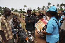 A UNICEF worker speaks with drivers of motorcycle taxis about the symptoms of Ebola virus disease (EVD) and best practices to help prevent its spread, in the city of Voinjama, in Lofa County, Liberia