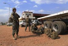 Sgt. John T. Kelly, (L) a radio operator with Special-Purpose Marine Air-Ground Task Force Crisis Response, calls in a status update during an evacuation of personnel from the U.S. Embassy in this handout photo taken in Juba