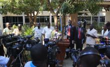 South Sudan Vice President James Igga (C) announces to the media the recapture of Malakal town by government forces from the rebels, in the capital Juba