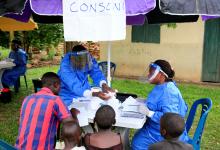 Ugandan health workers speak to civilians before carrying out the first vaccination exercise against the ebola virus in Kirembo village, near the border with the Democratic Republic of Congo in Kasese district, Uganda, June 16, 2019. PHOTO BY REUTERS/James Akena