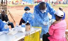 A Congolese health worker administers Ebola vaccine to a woman who had contact with an Ebola sufferer in the village of Mangina in North Kivu province of the Democratic Republic of Congo, August 18, 2018. PHOTO BY REUTERS/Olivia Acland