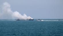 Smokes rises from an Egyptian coastguard vessel on the coast of northern Sinai, as seen from the border of southern Gaza Strip with Egypt, July 16, 2015. PHOTO BY REUTERS/Ibraheem Abu Mustafa