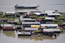 Villagers use a boat as they row past partially submerged houses at a flood-affected village in Morigaon district in Assam. PHOTO BY REUTERS/Anuwar Hazarika