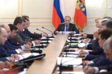 Russia's President Vladimir Putin (C) chairs a government meeting at the Novo-Ogaryovo state residence outside Moscow