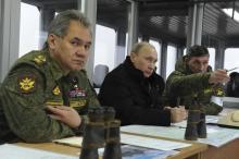 Russia's President Vladimir Putin (C), Defence Minister Sergei Shoigu (L) and head of the Russian army's main department of combat preparation Ivan Buvaltsev watch military exercises at the Kirillovsky firing ground in the Leningrad region, March 3, 2014. PHOTO BY REUTERS/Mikhail Klimentyev