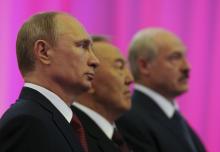 Russian President Vladimir Putin (L), Kazakh President Nursultan Nazarbayev (C) and Belarus President Alexander Lukashenko stand for a photograph before a meeting of the Eurasian Economic Union in Astana