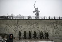 Soldiers walk near the Motherland Calls statue in Volgograd