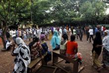 People wait for the opening of the polling office at Hamdalaye neighbourhood during a presidential election in Conakry, Guinea, October 11, 2015. PHOTO BY REUTERS/Luc Gnago