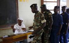 Police and soldiers wait to cast their ballots at a voting station in Burundi's capital Bujumbura during the country's presidential elections, July 21, 2015. PHOTO BY REUTERS/Mike Hutchings