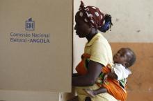 A woman carrying a baby on her back casts her vote during the national elections in the capital of Luanda, August 31, 2012. PHOTO BY REUTERS/Siphiwe Sibeko