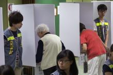 People vote at a polling station during a civil referendum held by Occupy Central in Hong Kong