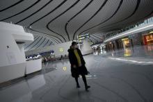 A woman wearing a face mask walks at the Beijing Daxing International Airport, as the country is hit by an outbreak of the novel coronavirus, in Beijing, China, February 20, 2020. PHOTO BY REUTERS/Tingshu Wang