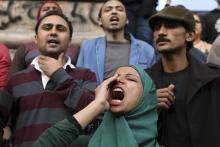 A woman shouts anti-government slogans during a protest against the court dropping its case against Egypt's former President Hosni Mubarak, in Cairo, December 2, 2014. PHOTO BY REUTERS/Mohamed Abd El Ghany